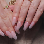 Reusable nail extensions clean manicure in long almond length.