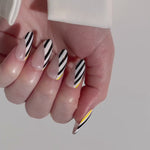 Reusable nail extensions abstract art in long almond length.